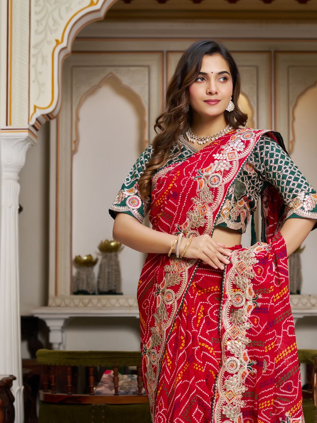 Woman wearing red pure Bandhej saree with heavy pitha & gota patti embroidery, front pose