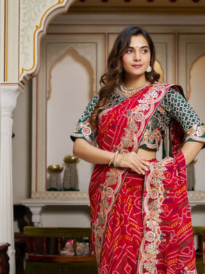 Woman wearing red pure Bandhej saree with heavy pitha & gota patti embroidery, front pose
