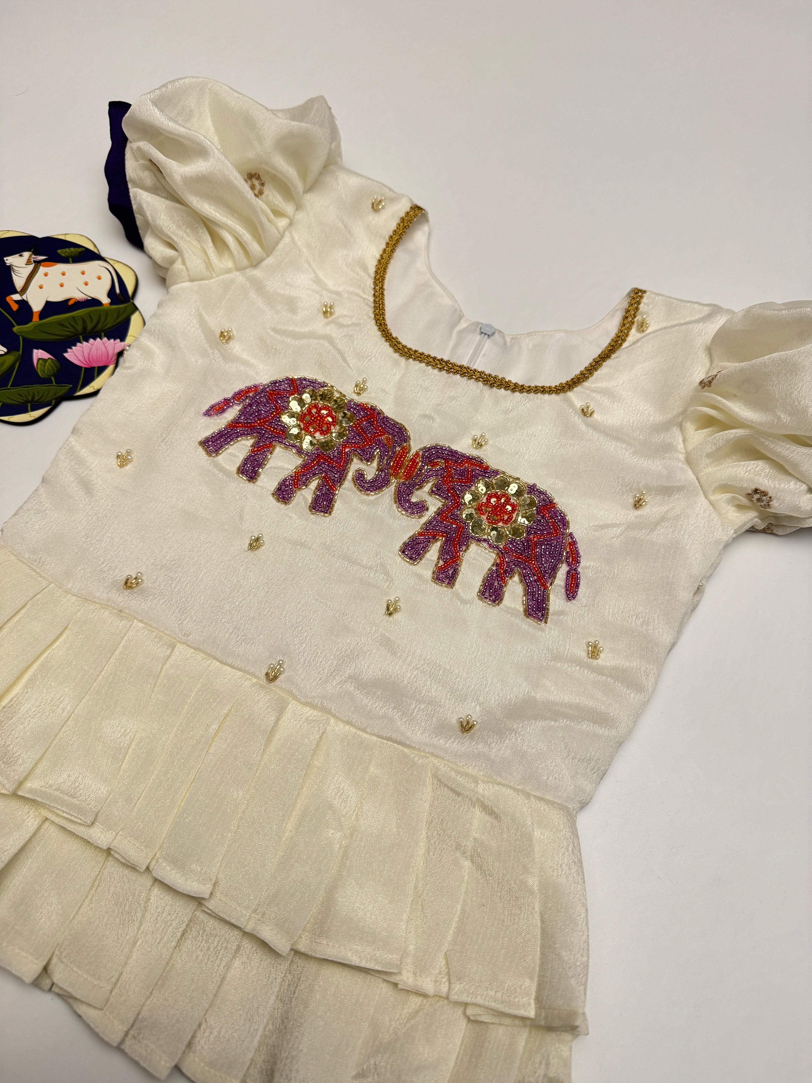 White blouse with embroidered elephants on a white background