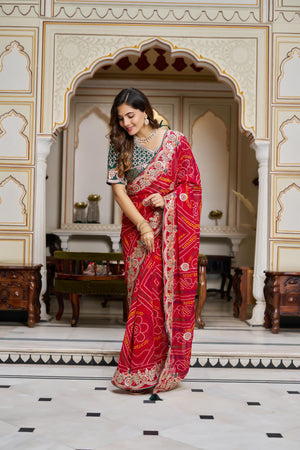Red Bandhej saree pallu draped elegantly with heavy embroidery detailing