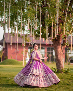 Woman in purple embroidered lehenga choli posing outdoors