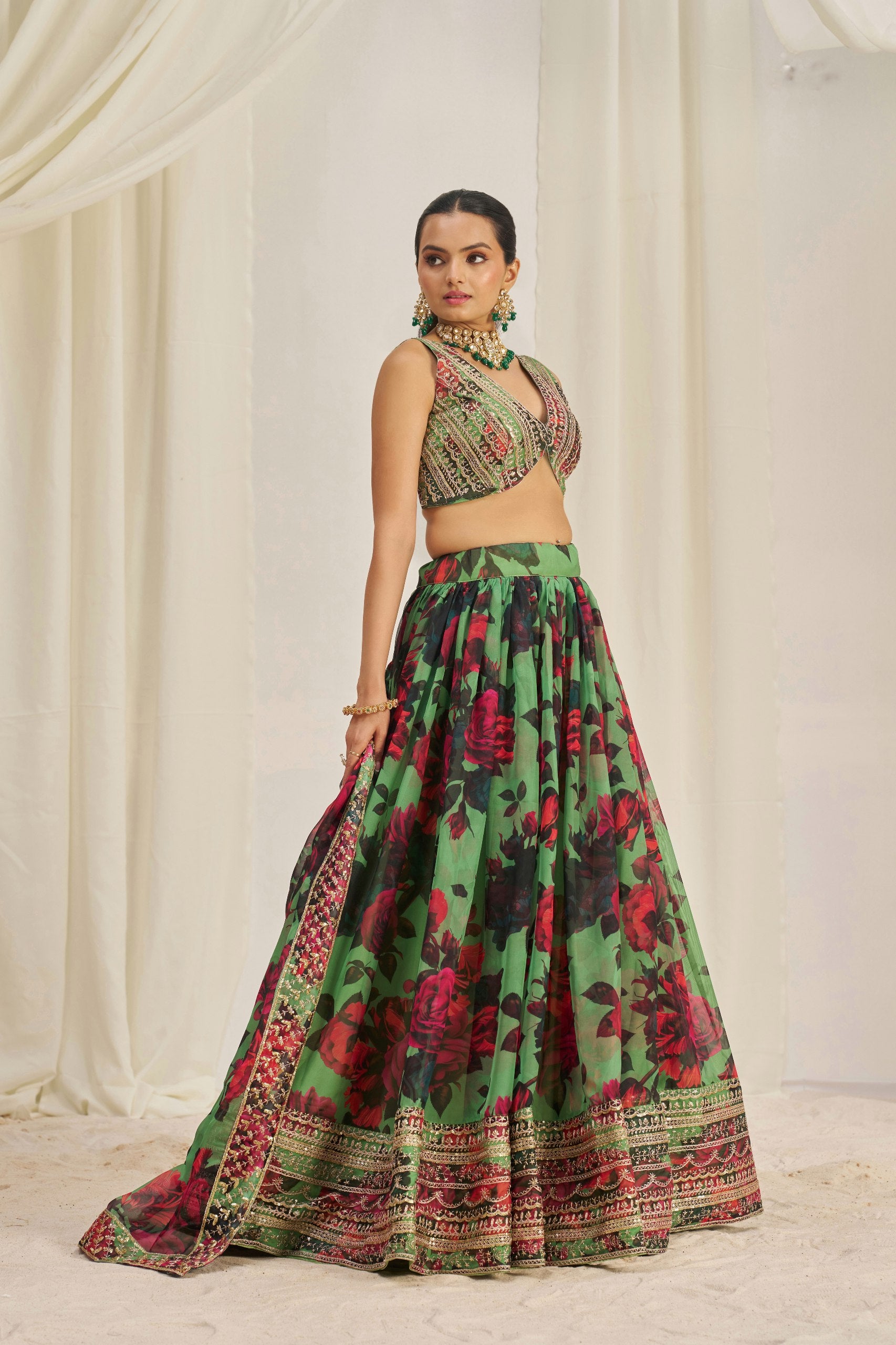 Model showcasing front pose in designer green lehenga