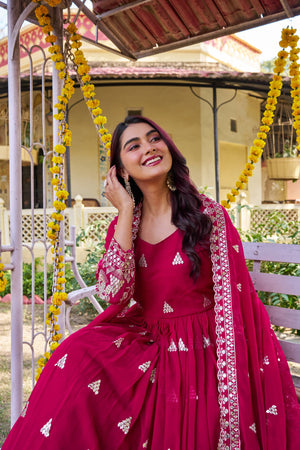Flowy pink gown with heavy embroidery in garden setting