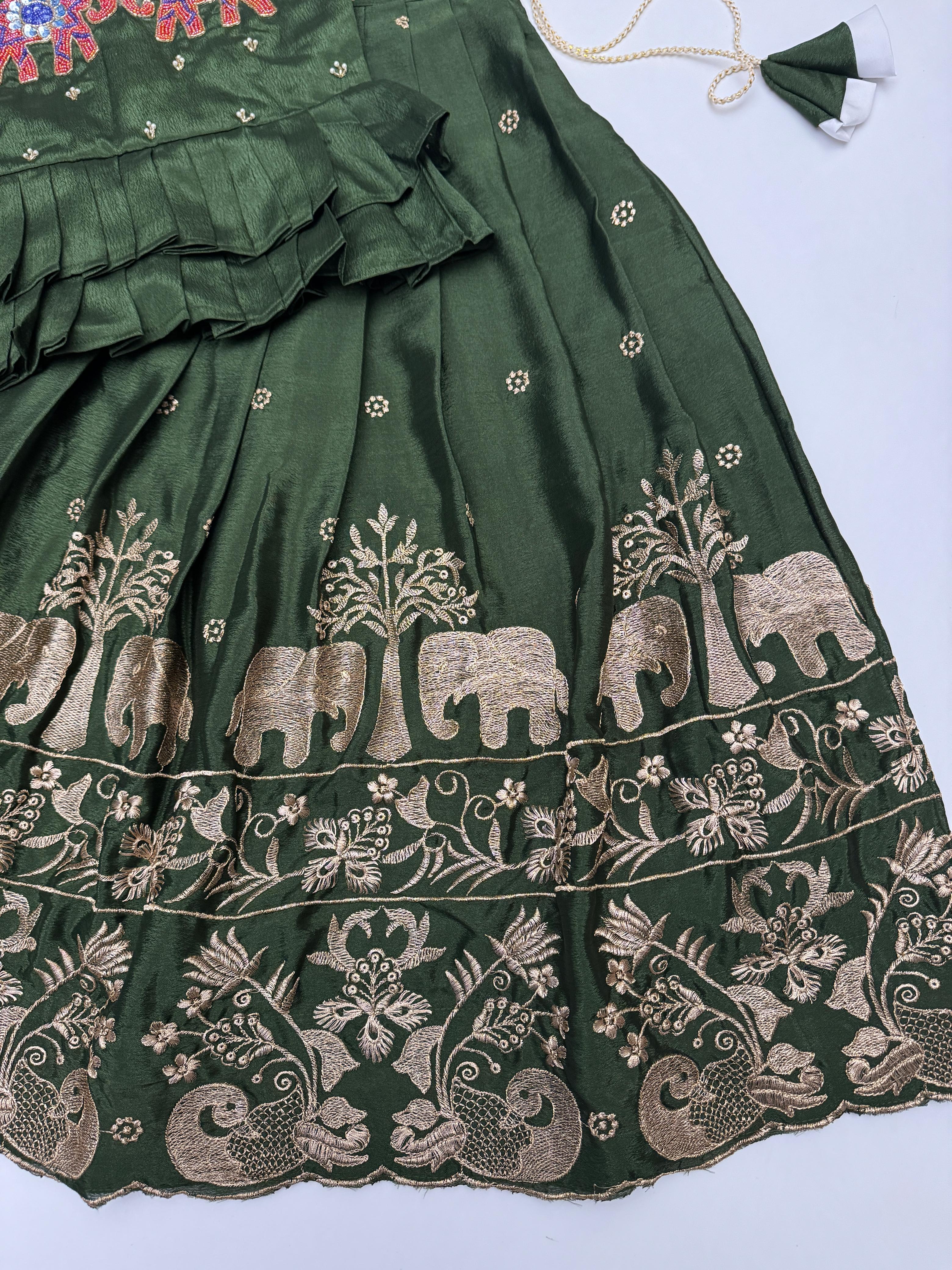 Green embroidered skirt with elephant design on a white background