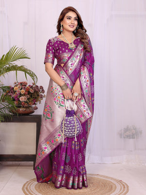 Woman wearing a purple saree with floral patterns in a well-lit room.
