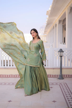 Woman in a green traditional outfit with a white building and blue sky in the background