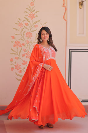Woman wearing an orange traditional festive embroidered gown for women.