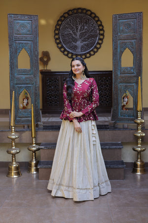 Woman in traditional outfit standing in a decorated room with wooden panels and decorative items.