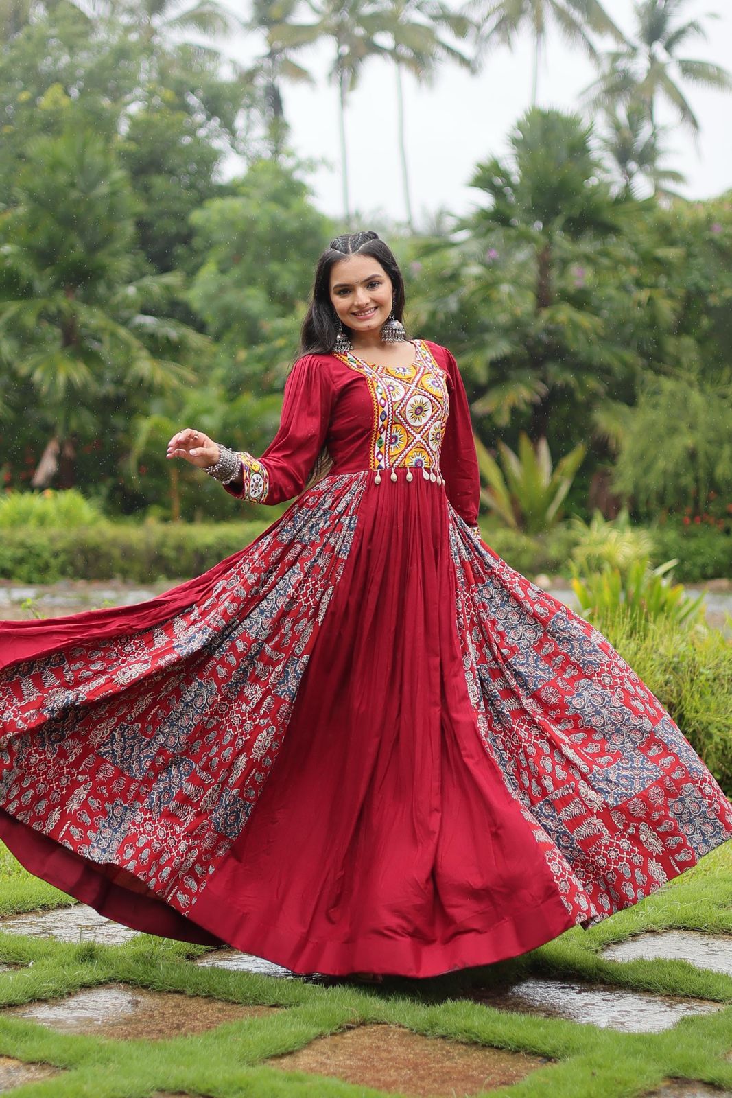 Model twirling in maroon printed Navratri gown