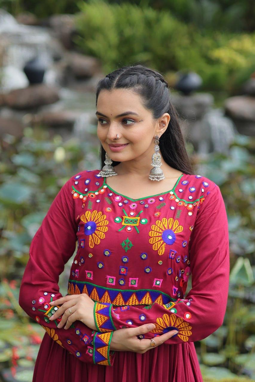 Close-up of Kutchi embroidery on maroon rayon gown