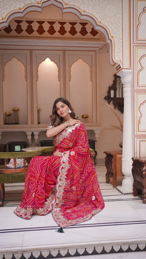 Red Bandhej saree pallu draped elegantly with heavy embroidery detailing