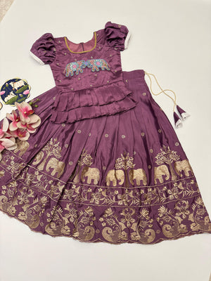 Purple dress with elephant patterns on a white background