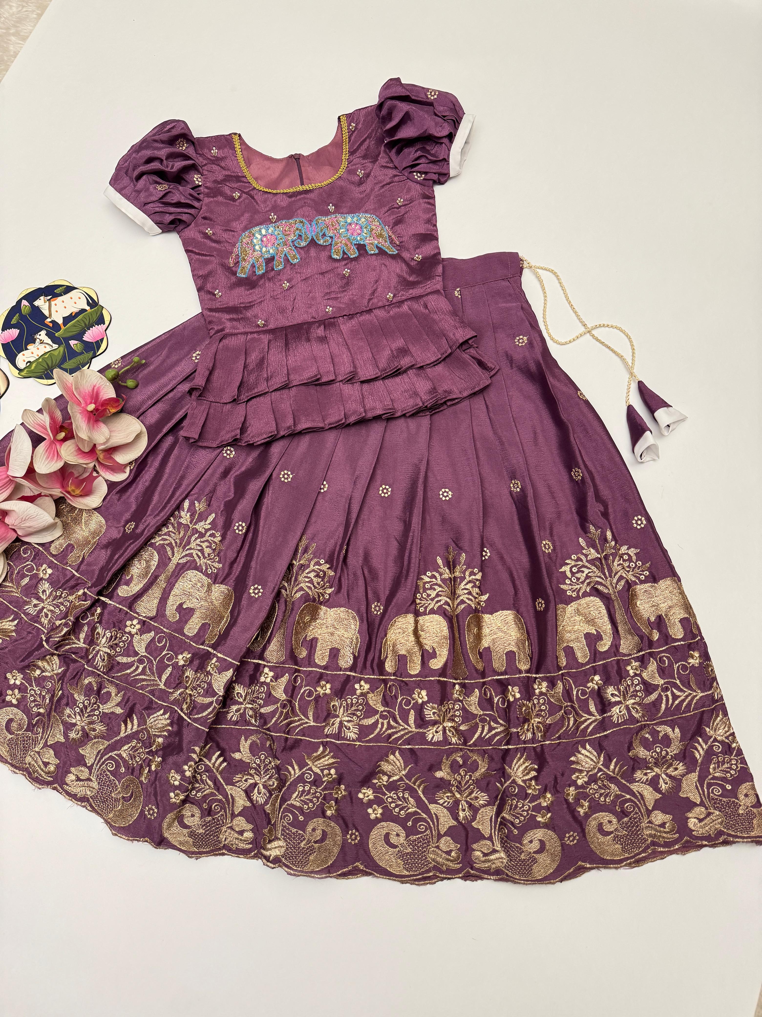 Purple dress with elephant patterns on a white background