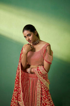 Close-up of sequins and cording embroidery on red lehenga