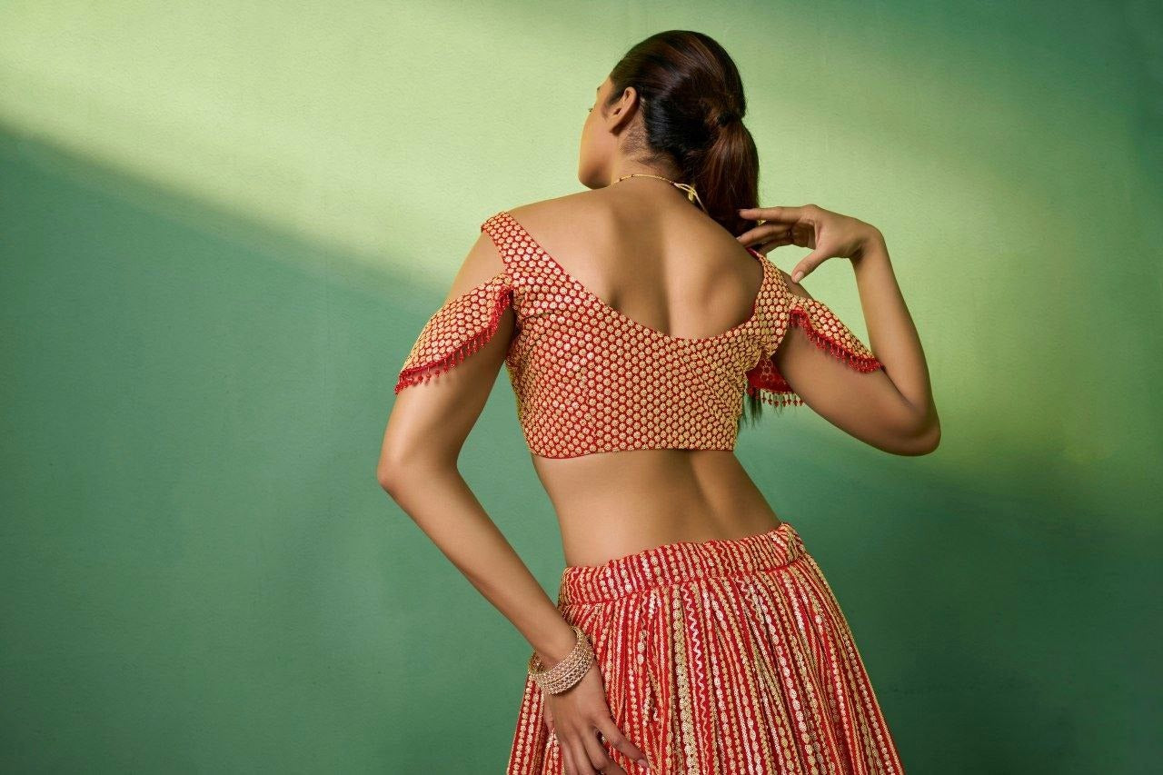 Heavy embroidered red lehenga with golden detailing