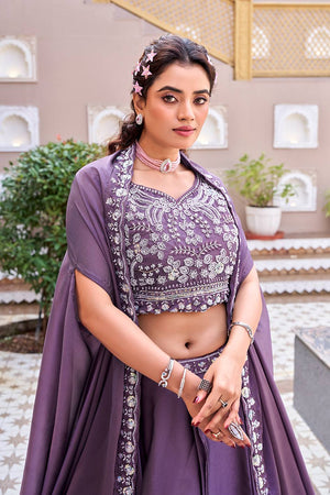 Woman in a purple traditional outfit with floral patterns in an outdoor setting
