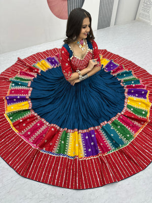 Woman in a colorful traditional outfit with a large, round, multicolored skirt.
