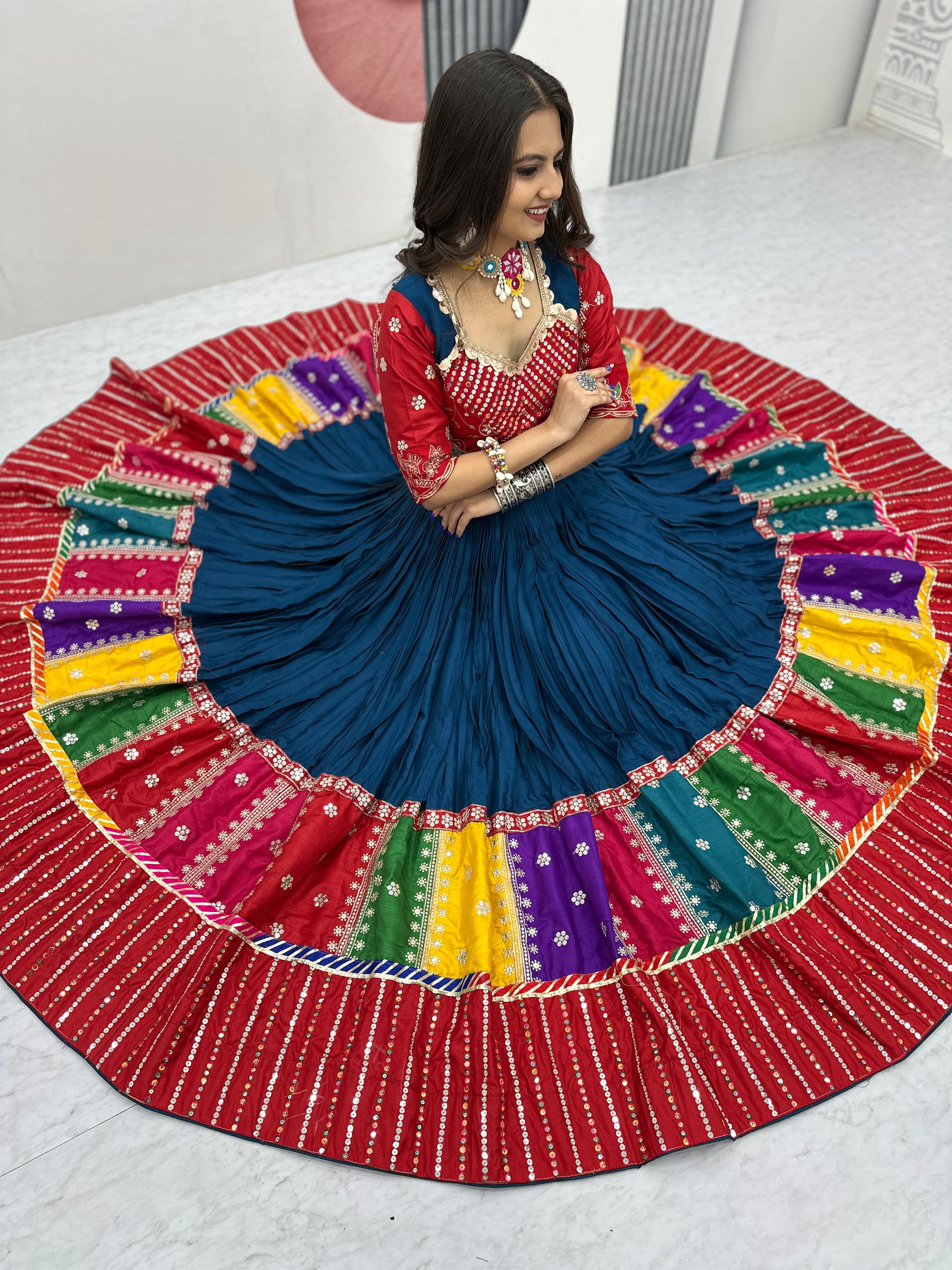 Woman in a colorful traditional outfit with a large, round, multicolored skirt.