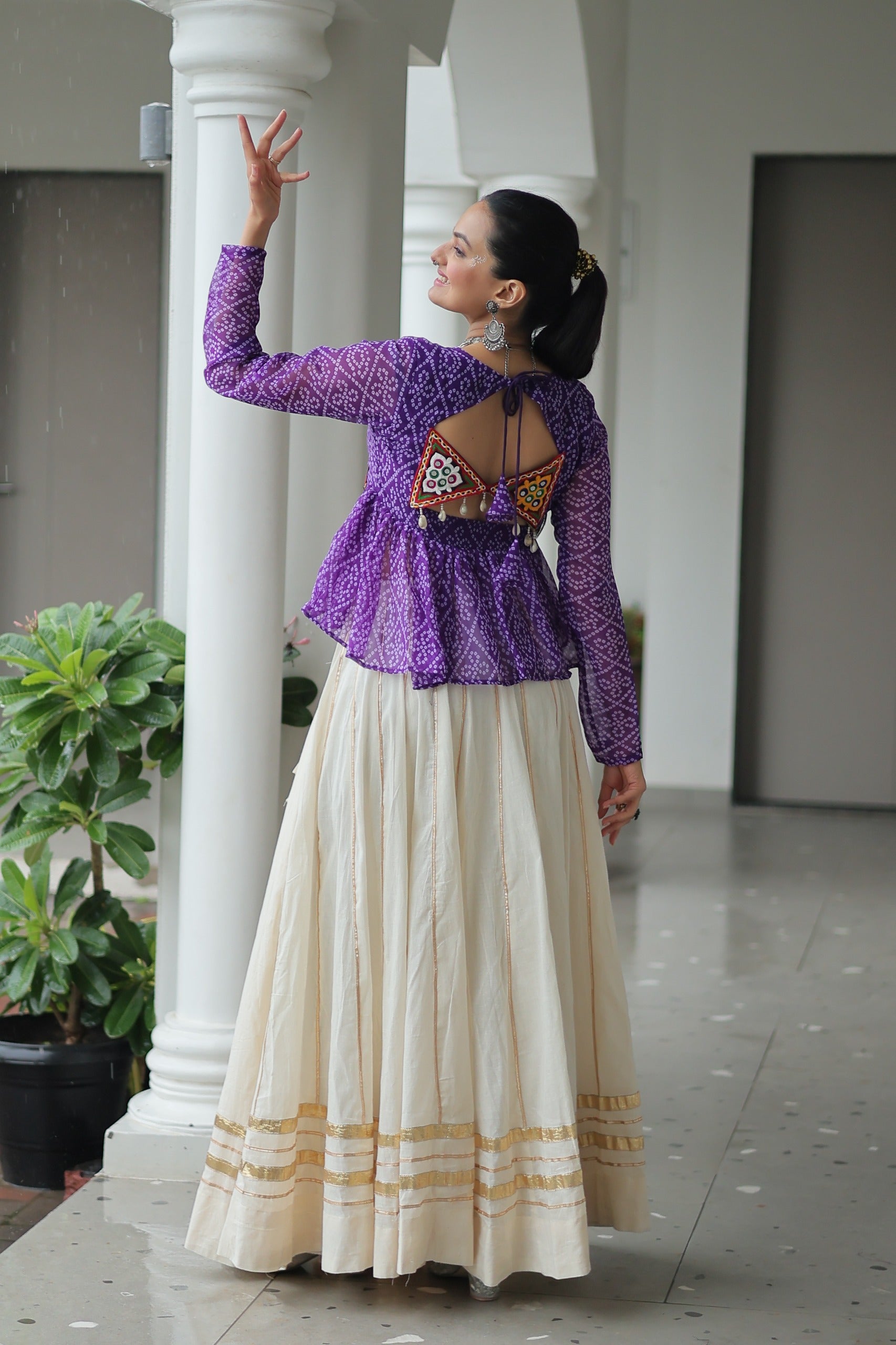 Model posing in Purple Bandhani and Kora Cotton Lehenga