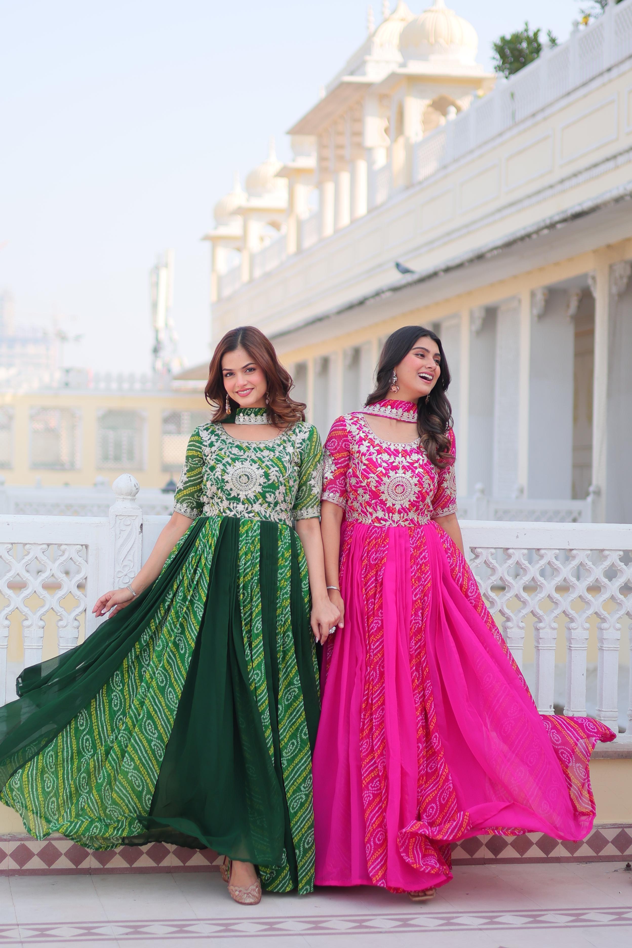 Two women in traditional dresses standing on a balcony with a building in the background