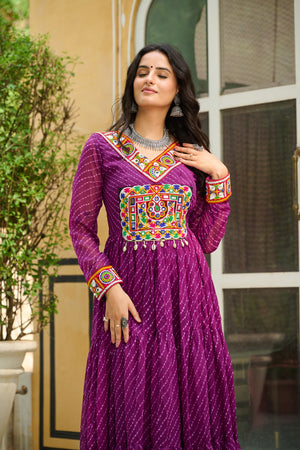 Woman wearing a vibrant purple traditional outfit with colorful embroidery outdoors.