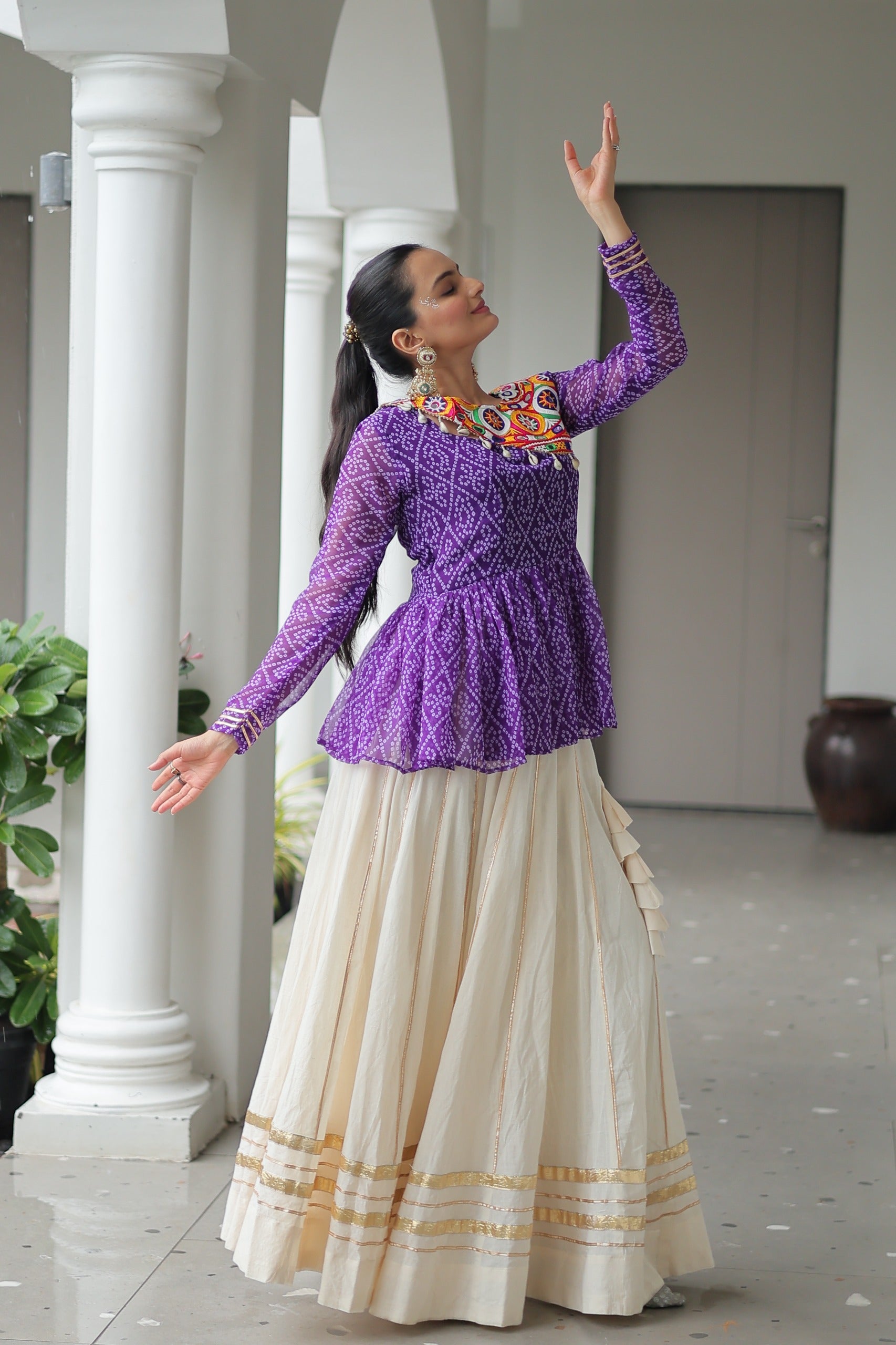Model in festive pose wearing Kutchi Lehenga
