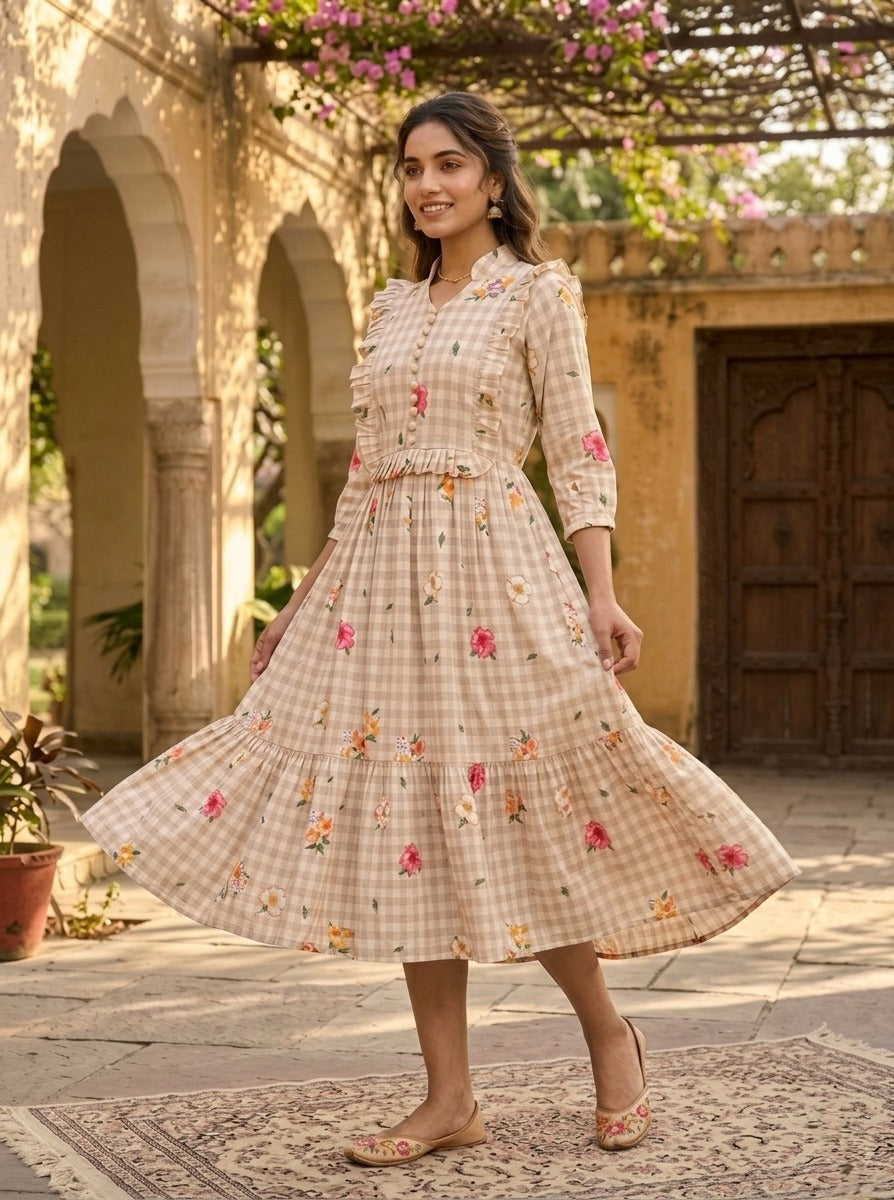 Woman in a floral dress standing in an outdoor setting with architectural elements.