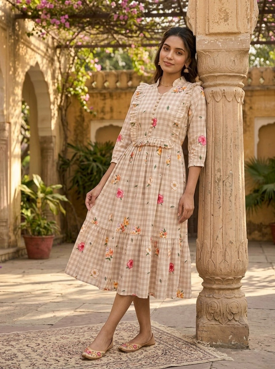 Woman in a floral dress standing next to a decorative column in an outdoor setting.