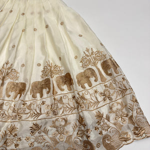 Embroidered fabric with elephants and floral patterns on a white background