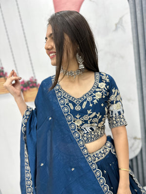 Woman wearing a blue embroidered saree with a blurred background