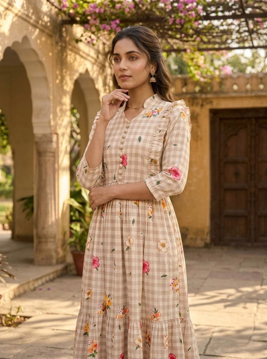 Woman wearing a checkered dress with floral embroidery in an outdoor setting.