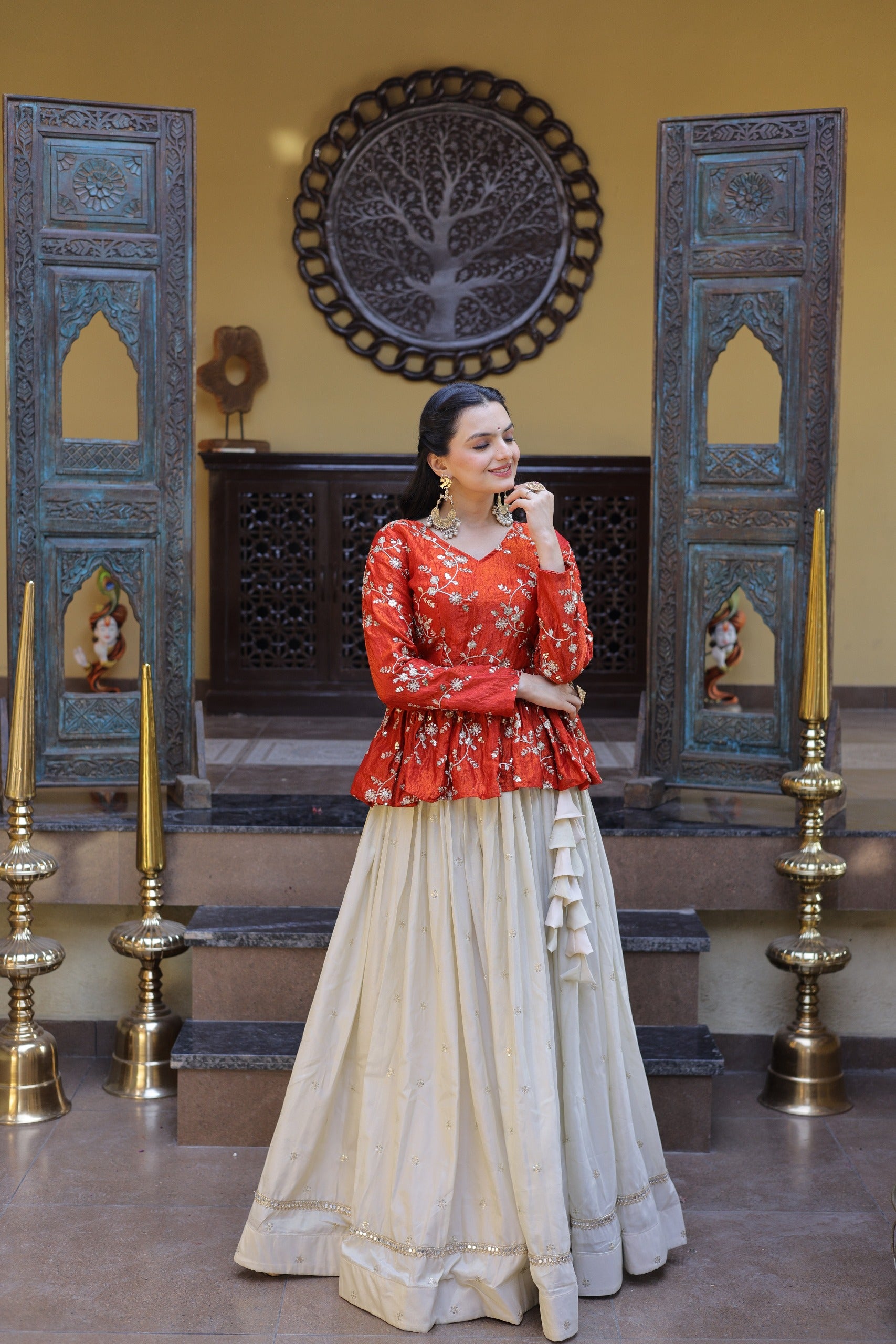 This stylish lehenga set with peplum blouse is perfect for wedding events and celebrations.