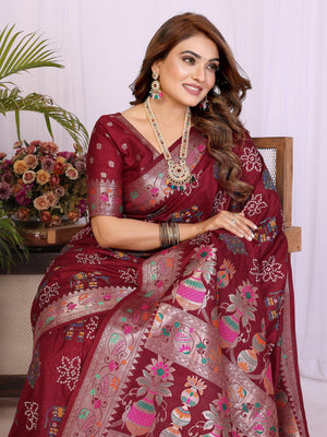 Woman wearing a maroon saree with floral patterns indoors