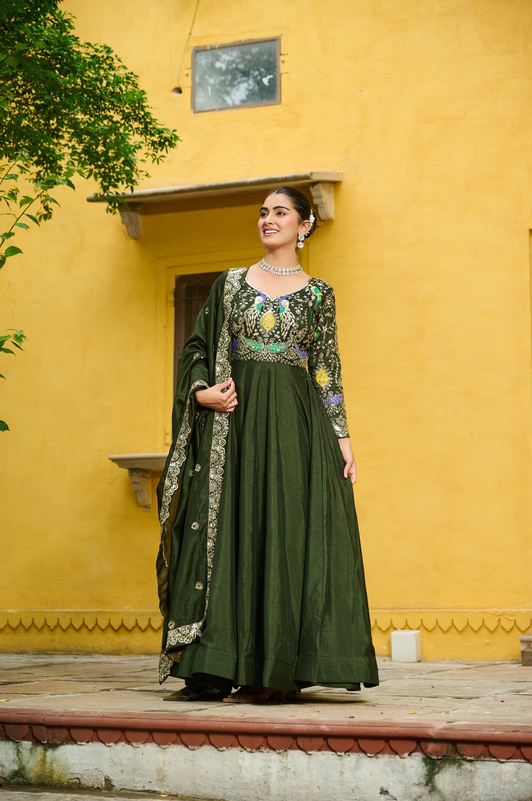Elegant Mehendi Vichitra fabric gown with intricate zari embroidery and full sleeves