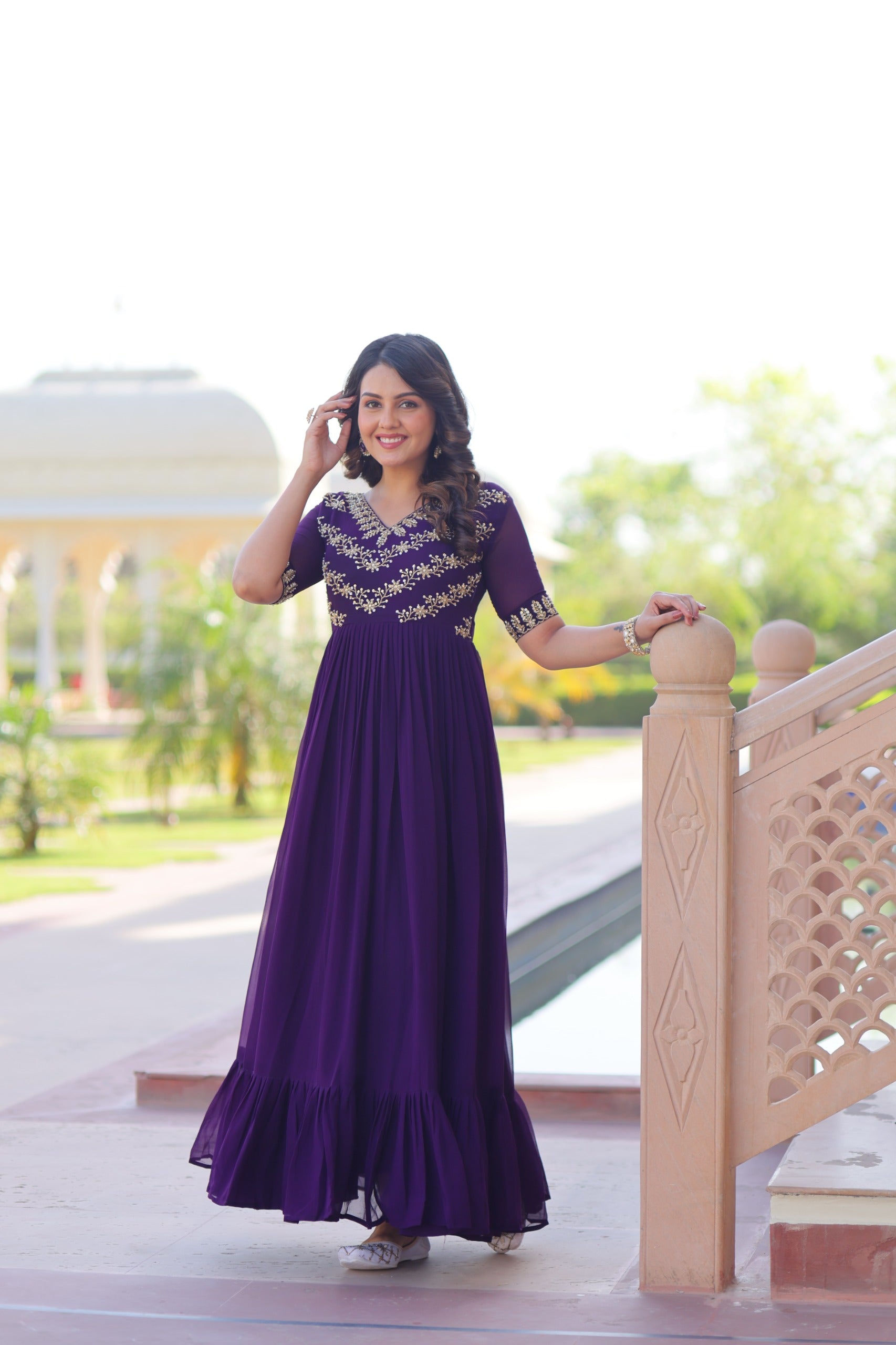 Designer party wear gown in royal purple with stylish V-neck