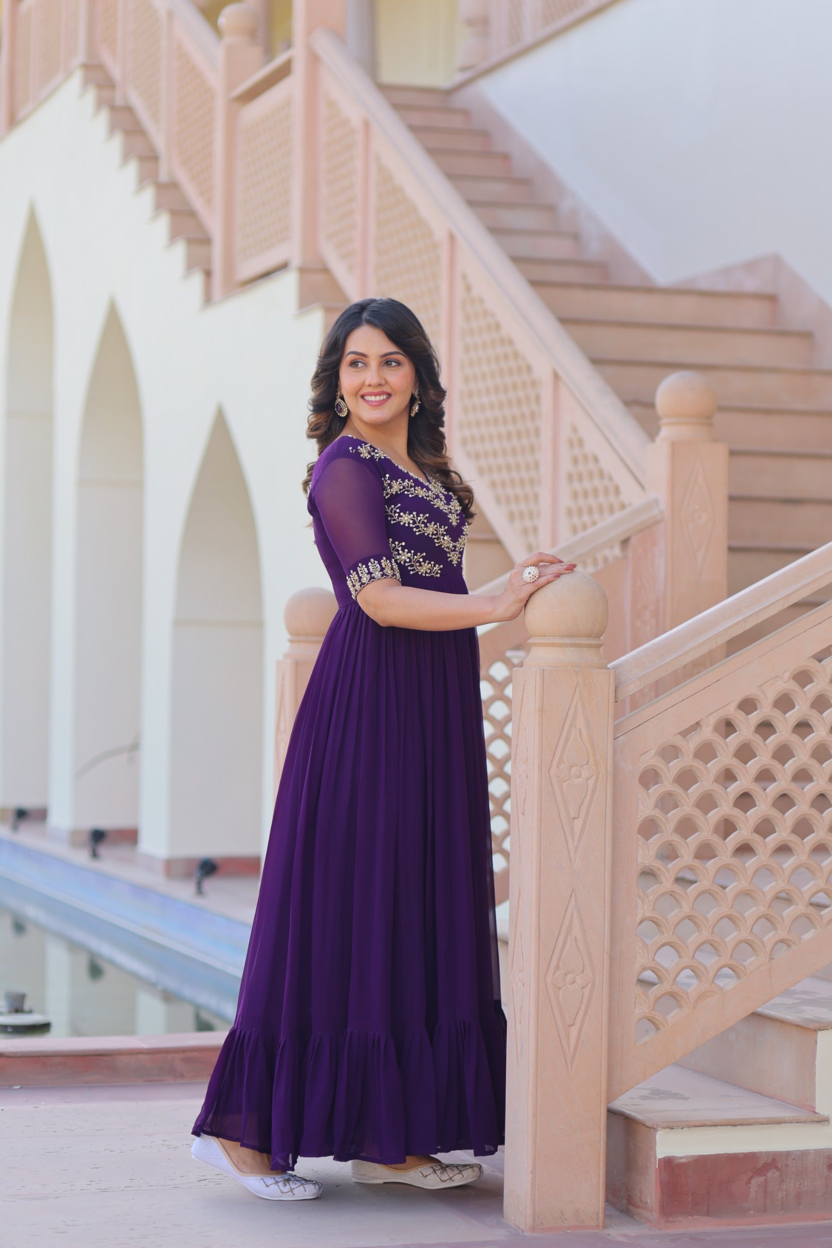 Side profile of frill-stitched purple gown with elegant flair