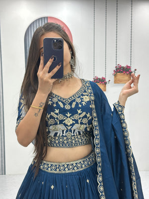 Full length teal lehenga with embroidered border and elephant motifs
