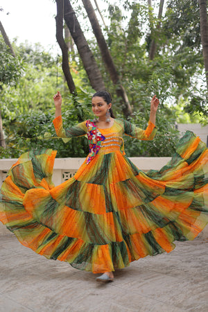 Model twirling in Green-Orange Kutchi Work Gown