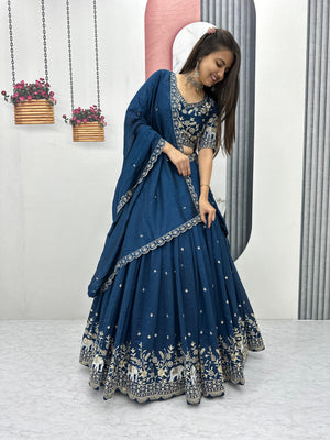  wedding lehenga
Woman in a blue traditional outfit with white patterns standing indoors.
