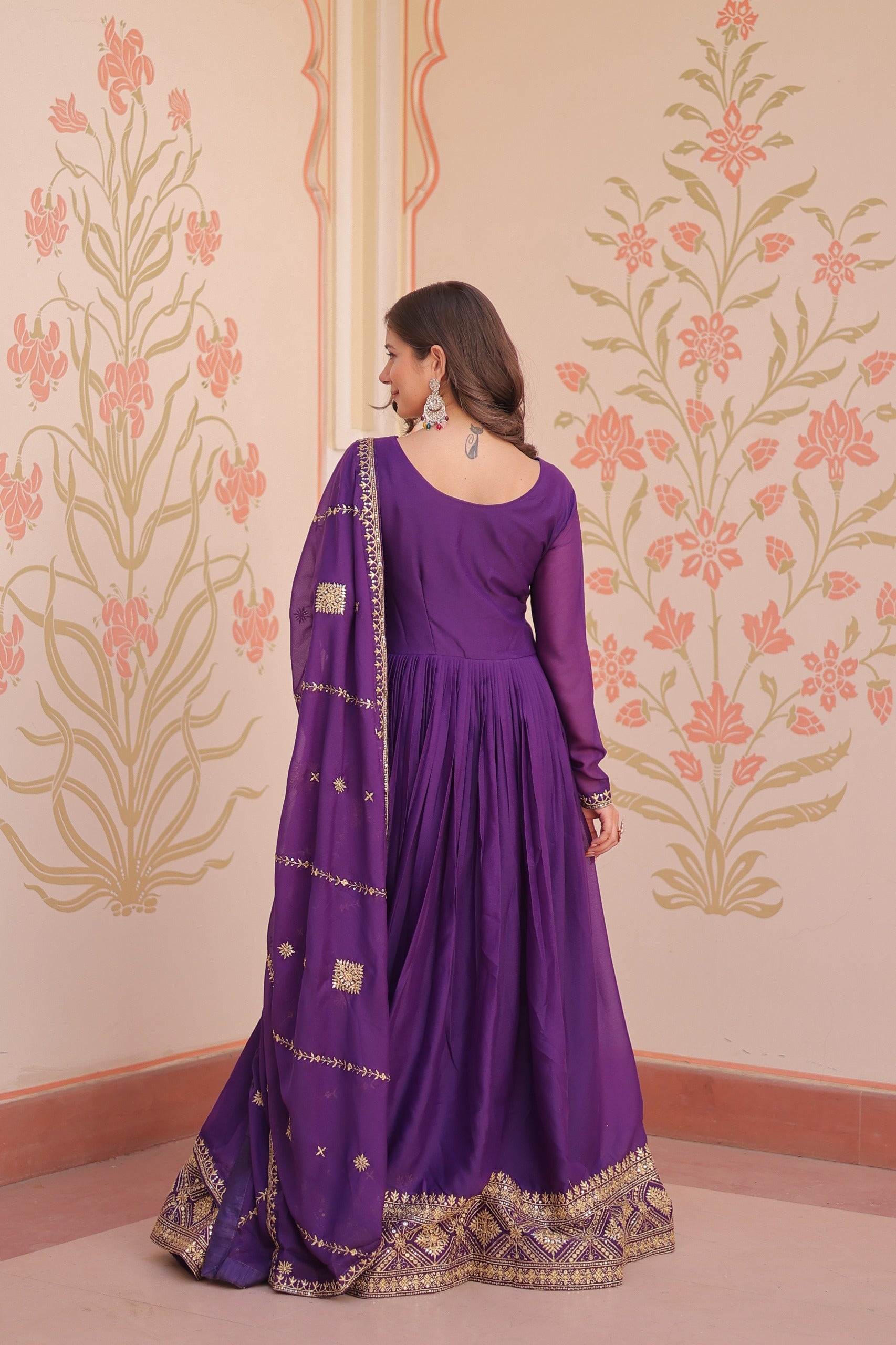 Full sleeve purple color gown with round neck and intricate embroidery