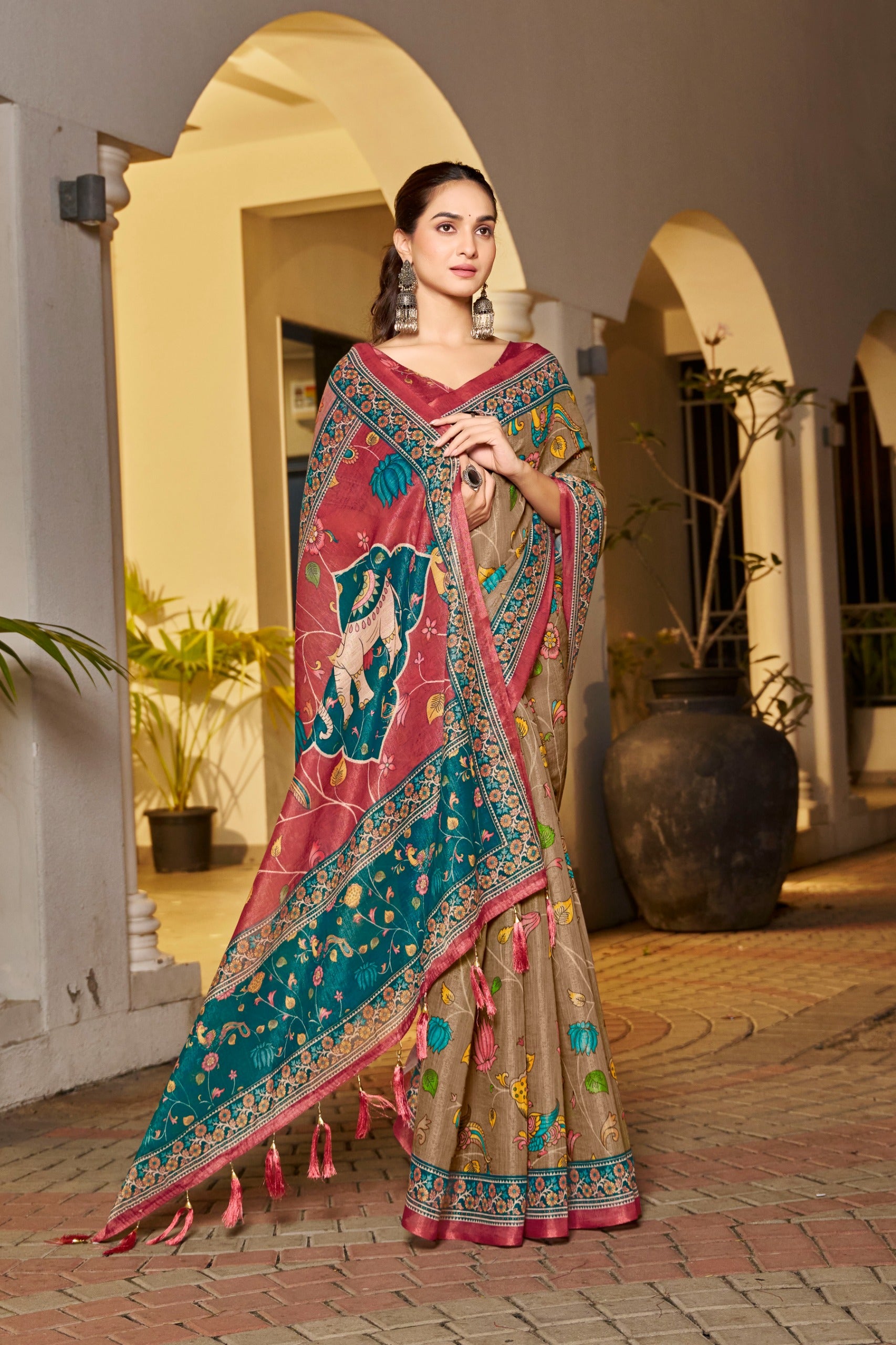 Beige saree with maroon tassels and folk artwork