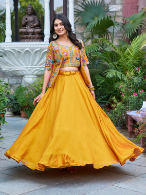 Woman in a yellow traditional outfit with a colorful top, Festival Lehenga Choli.